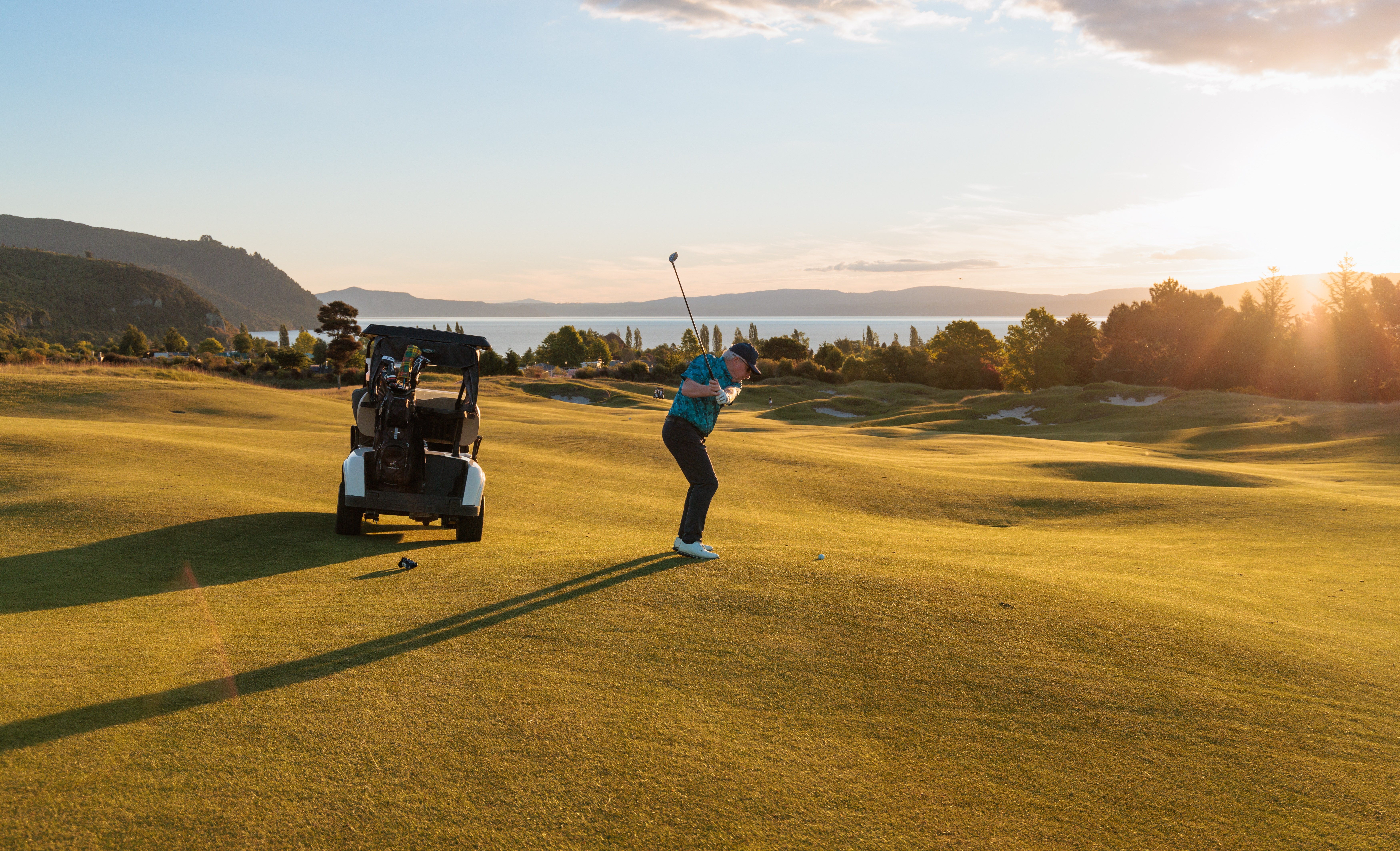 2504_img_taupo_region_kinloch_golf_club_man_tee_off_fairway_golf_cart_lake_view_relaxing_sport-1