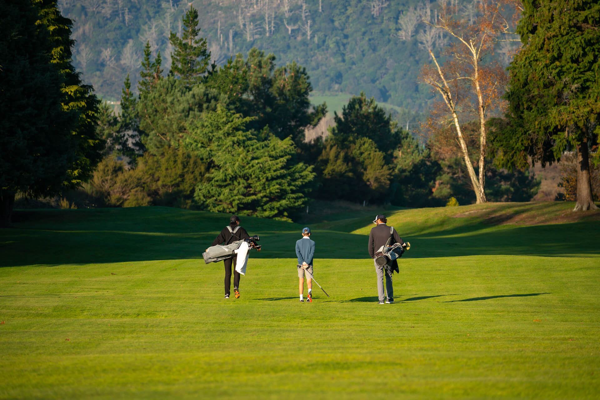 2505_img_taupo_golf_club_men_and_bot_walking_down_green